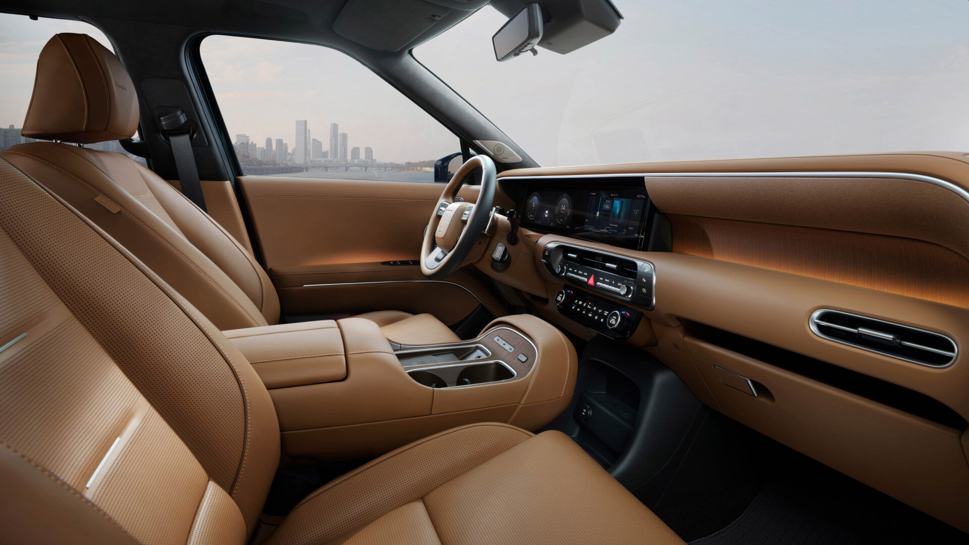 Side-front view of orange Grandi10 with lakeside view at night